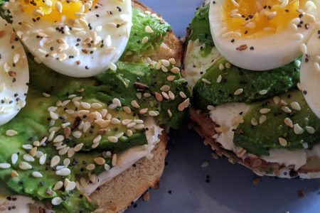 A breakfast sandwich topped with sesame seeds