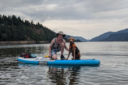 Dog and man paddle-boarding on the Columbia River