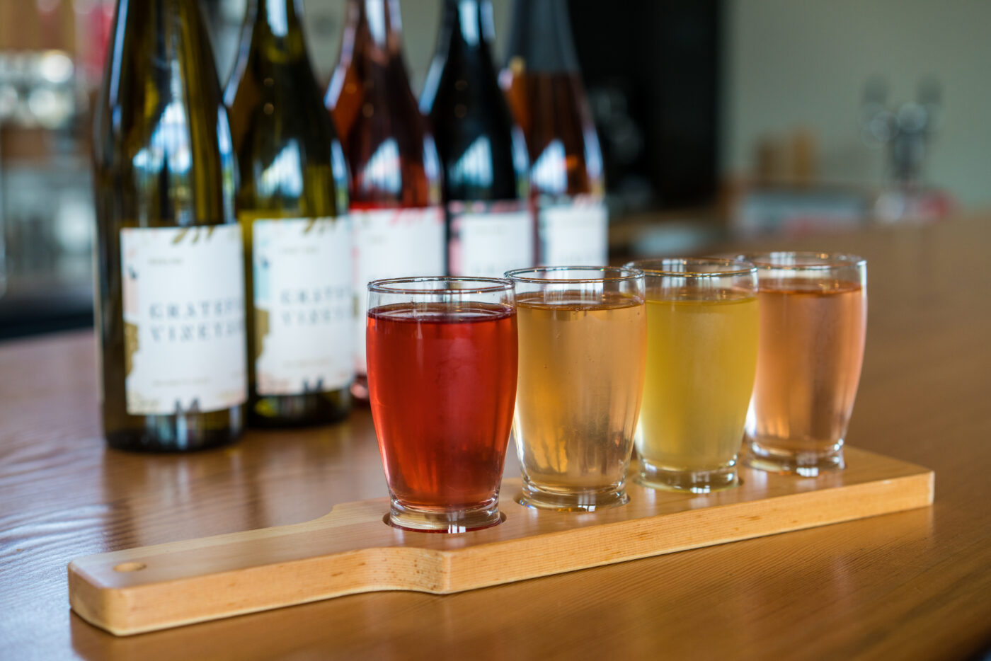 A drink flight with yellow to reddish hues.