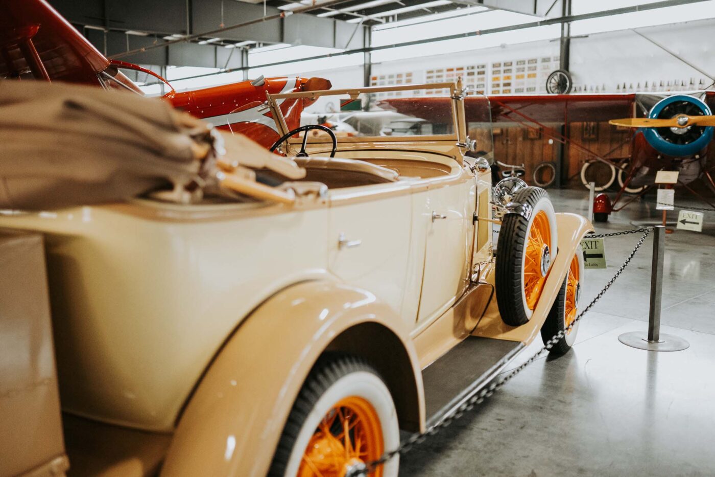 White classic car with orange tires at the Western Antique Aeroplane & Automobile Museum